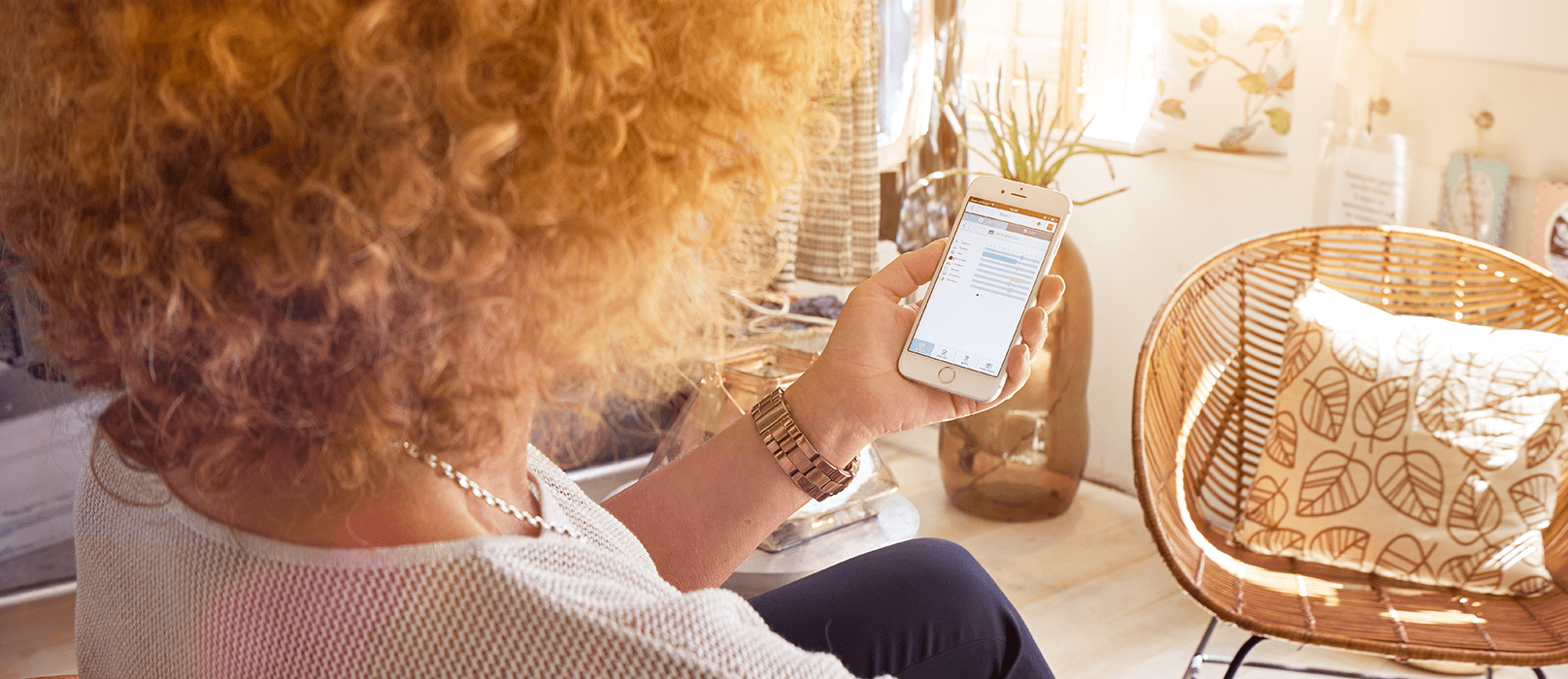 Caregiver checks cAlarm Sense on her smartphone